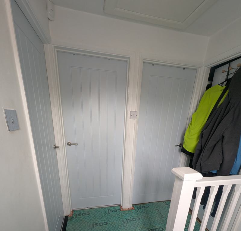 Landing with two doors and underlay on the floor before redecorating