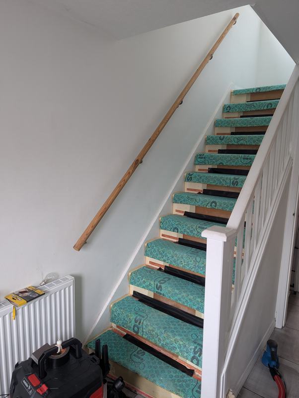 Staircase with underlay laid and plain walls before redecorating